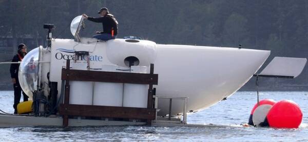 OceanGate CEO Stockton Rush emerges from the hatch atop the OceanGate submarine Cyclops 1 in the San Juan Islands, Wash., on Sept. 12, 2018. Rescuers in a remote area of the Atlantic Ocean raced against time Tuesday, June 20, 2023, to find a missing submersible before the oxygen supply runs out for five people, including Stockton, who were on a mission to document the wreckage of the Titanic. (Alan Berner/The Seattle Times via AP)